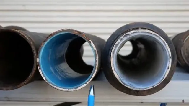Cutting old cast iron pipe outdoors seen during a routine plumbing job.