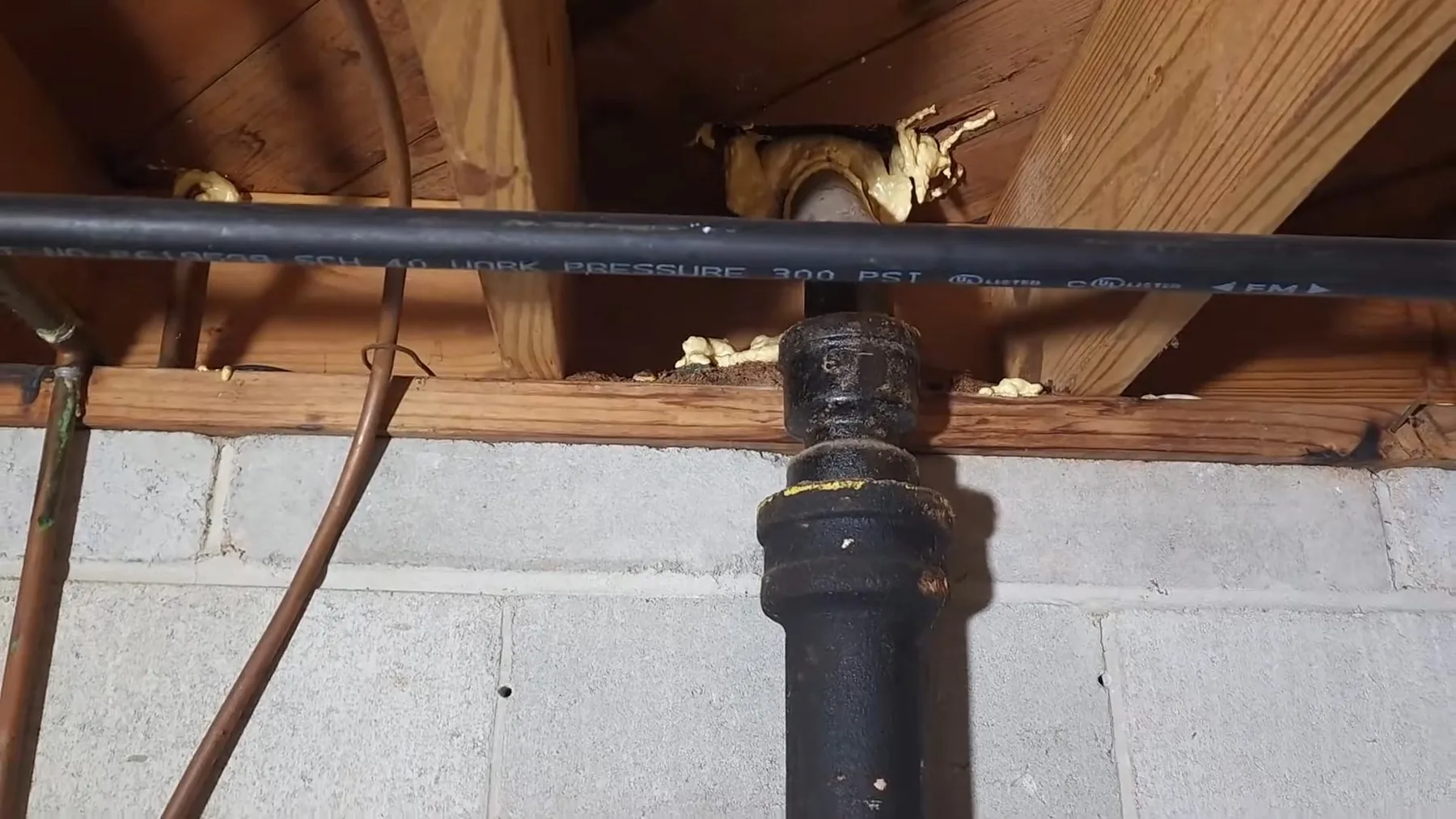 Close-up of the old cast iron sewer pipe replaced with PVC.