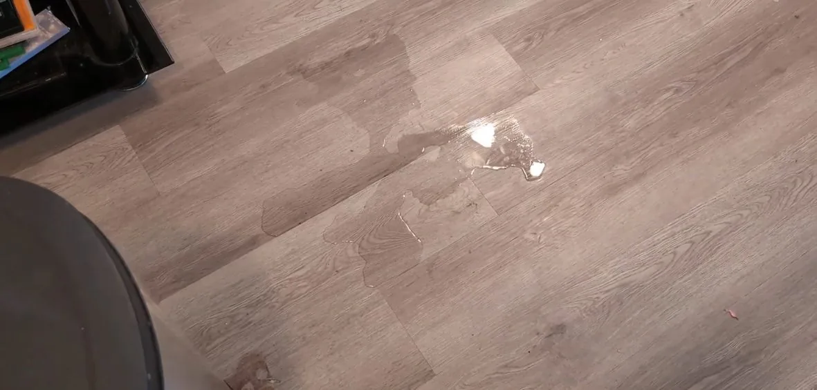 On-site photo of the wet tile floor from slab water leak.